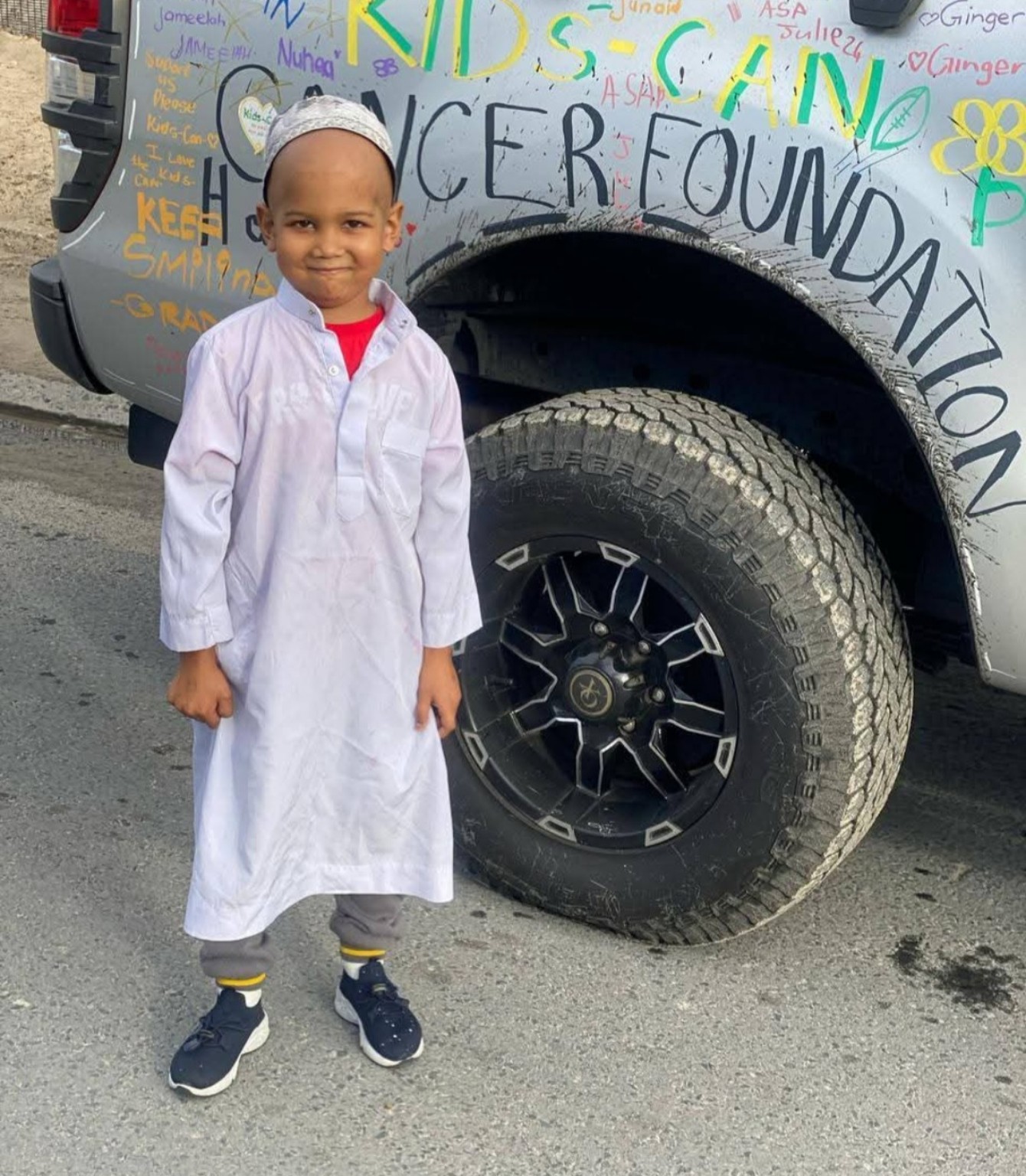 Rafeeq smiling at a childhood cancer awareness event